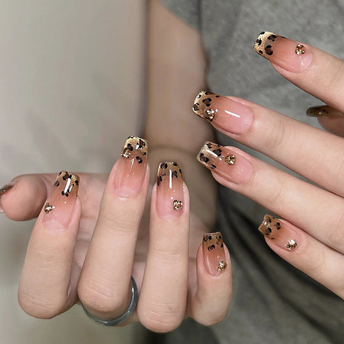 Artificial nails with shimmering leopard design and elegant accents Bowlift