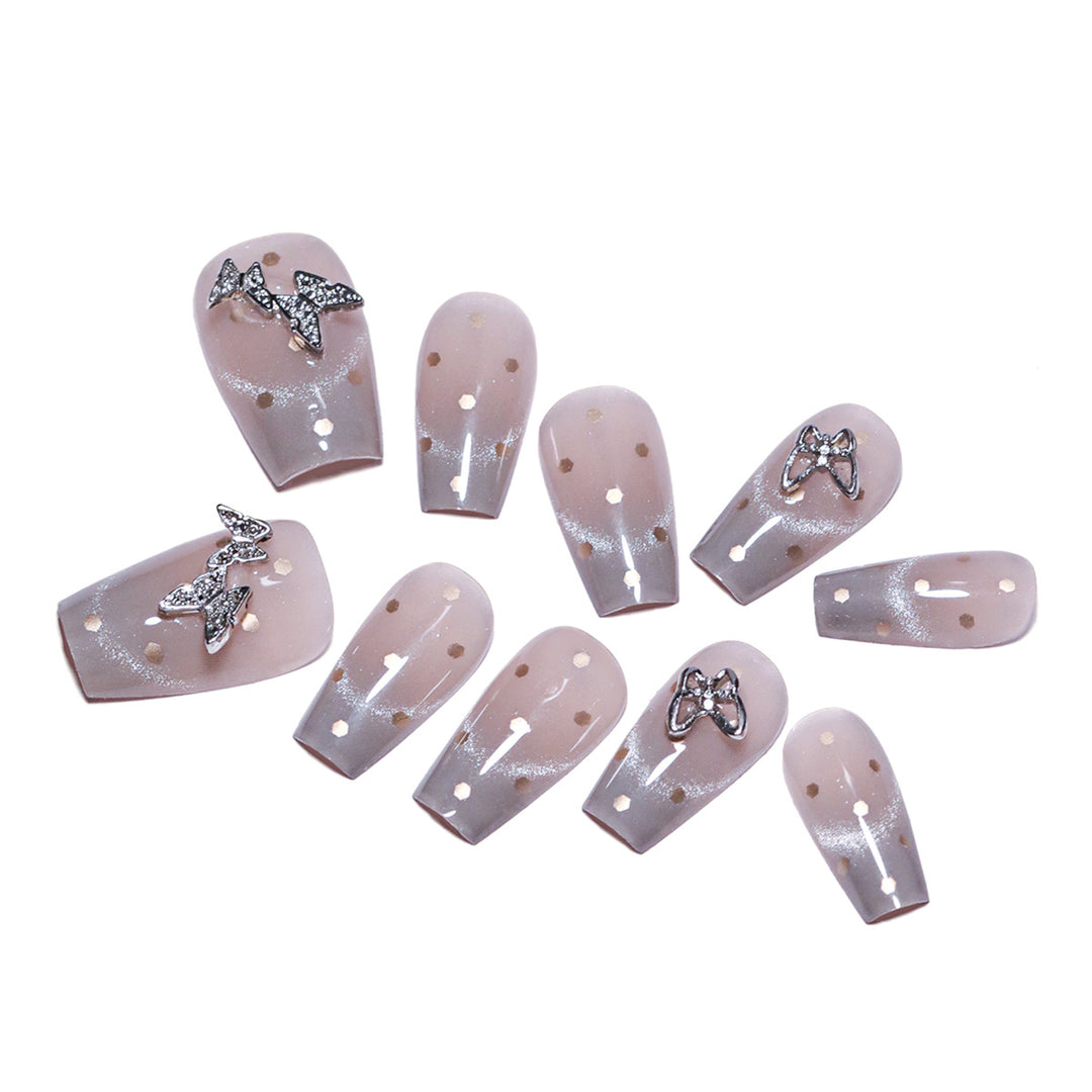 Artificial nail art with glitter details and bow accents Bowlift