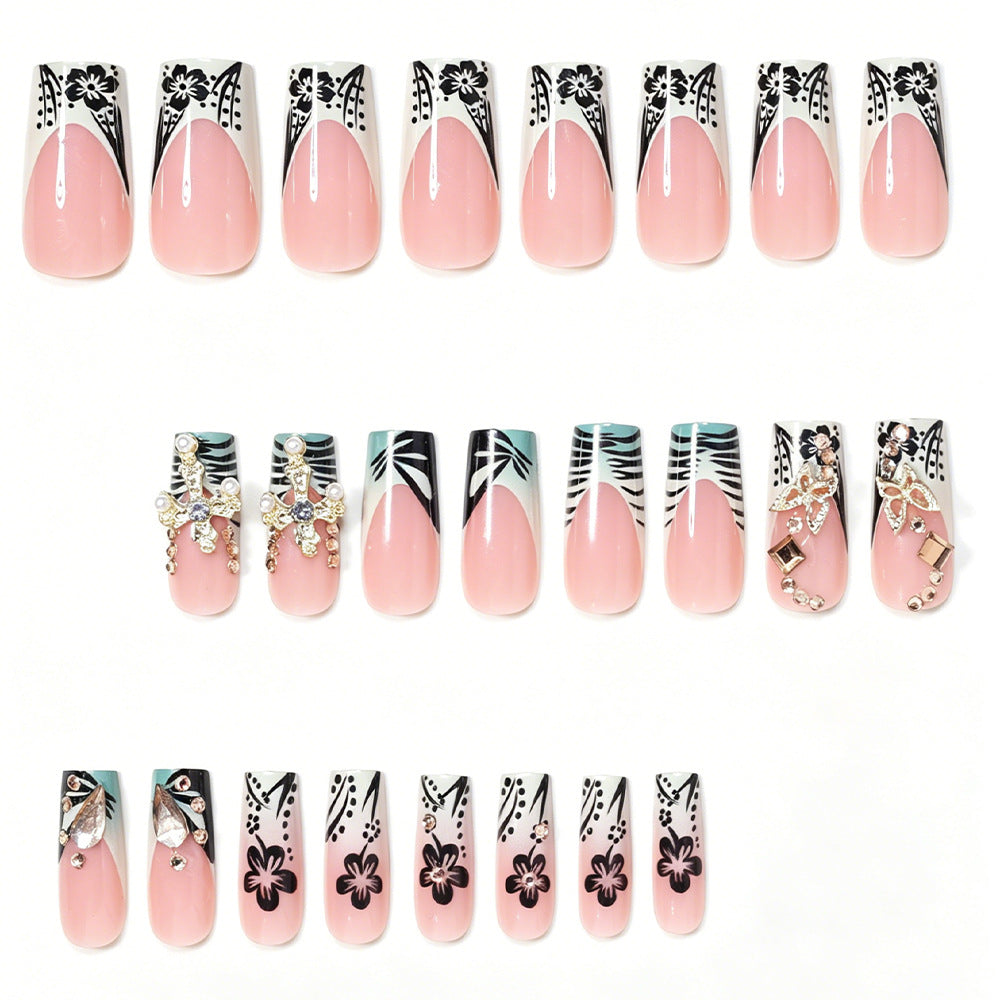 Artistic Stiletto Nail Design with Floral Accents and Gems Bowlift