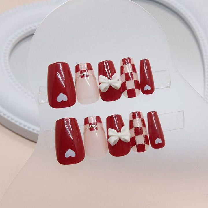 Artificial nails with decorative heart and bow details Bowlift