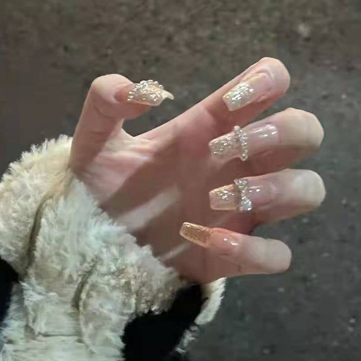 Glamorous artificial nails with heart-shaped accents Bowlift