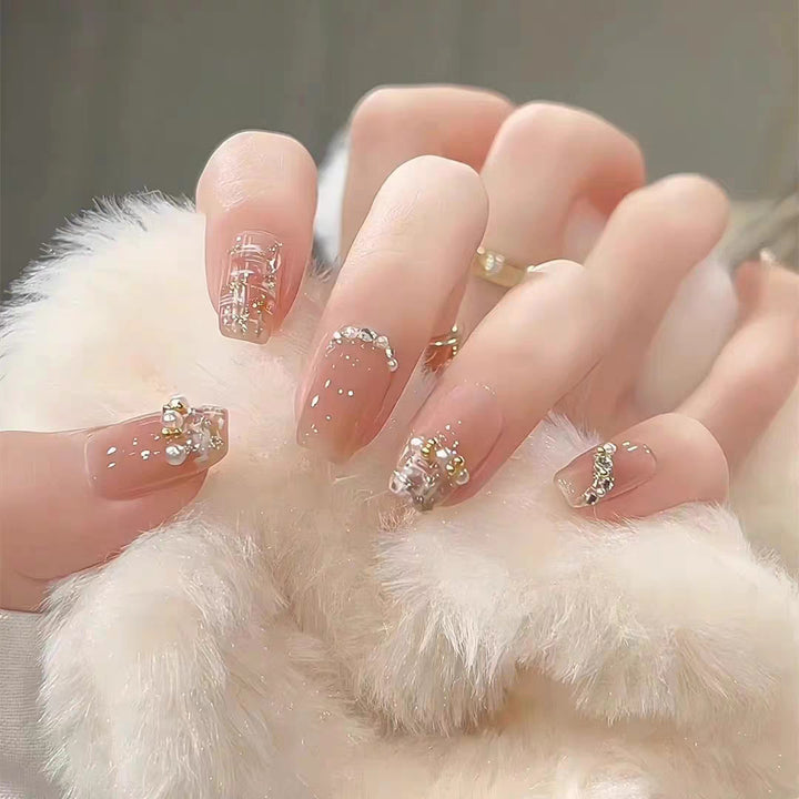 Artistic Press-On Nail Design with Floral and Glitter Accents Bowlift