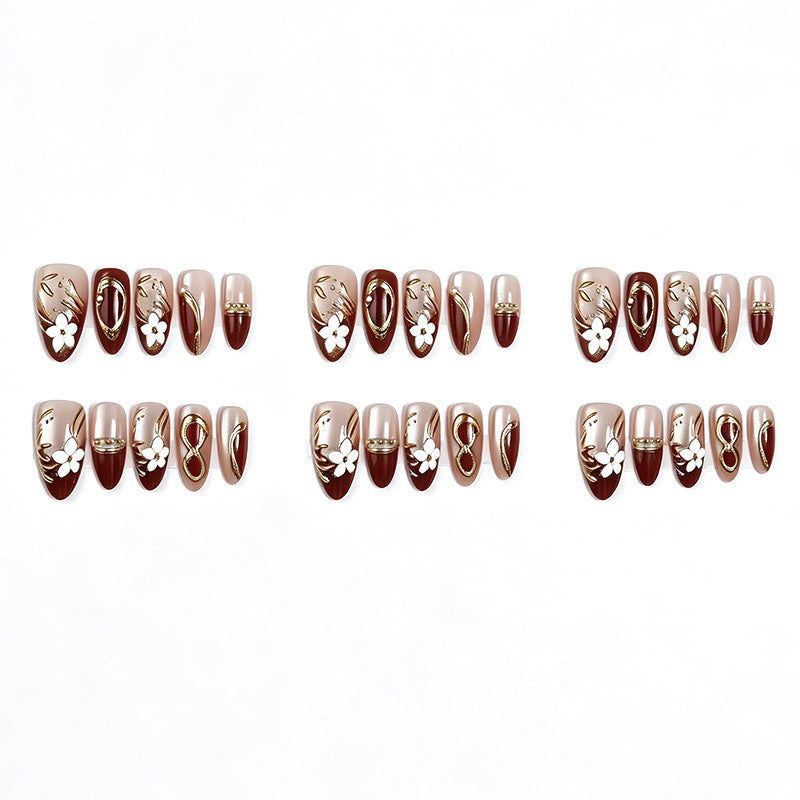 Artificial nail set with floral and glamorous gold embellishments Bowlift