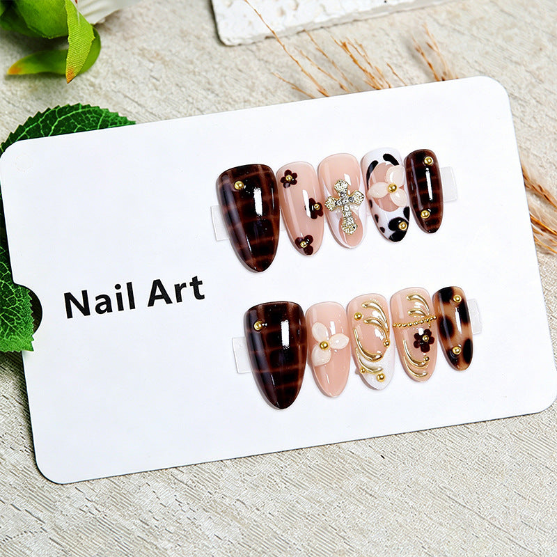Artificial nails set with elegant gold accents and floral embellishments Bowlift