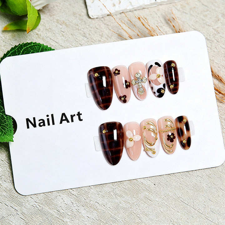 Artificial nails set with elegant gold accents and floral embellishments Bowlift