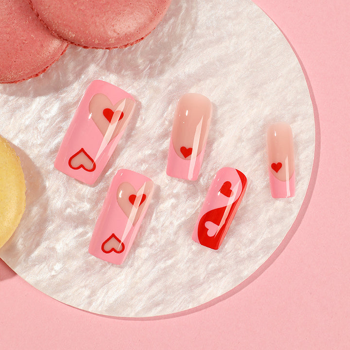 Artificial nail art with heart design and glitter accents Bowlift