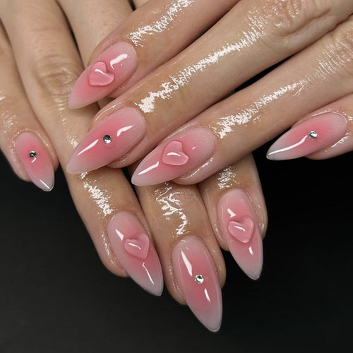 Artful stiletto nails with heart design and glitter accents Bowlift