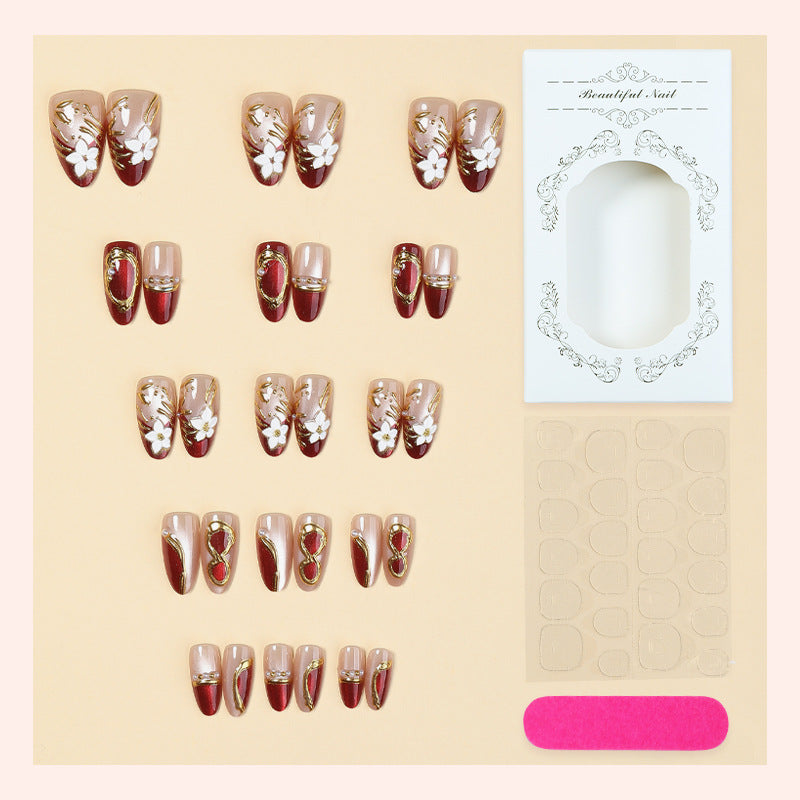 Artificial nail set with floral and glamorous gold embellishments Bowlift