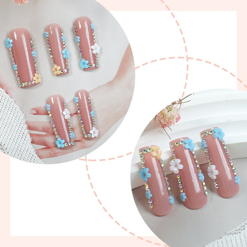 Artificial nail set with delicate flower embellishments and glitter accents Bowlift