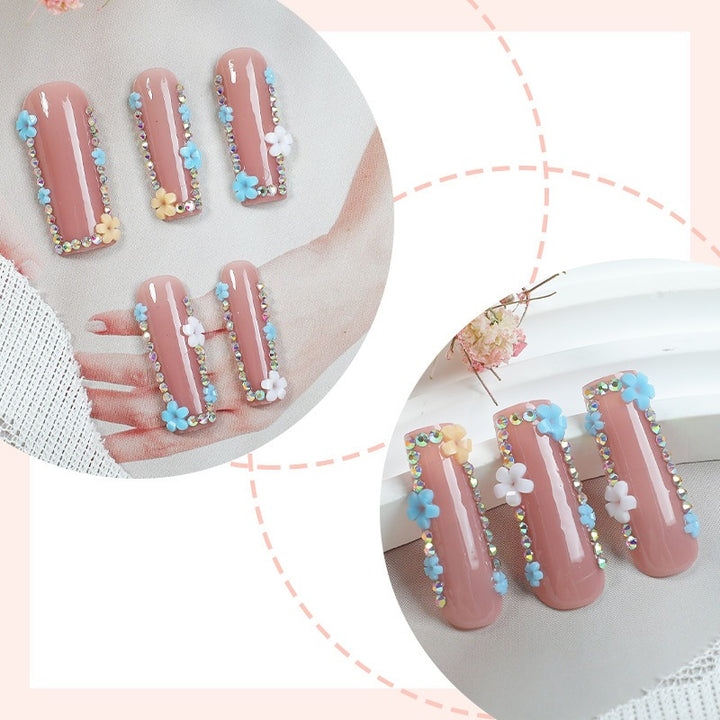 Artificial nail set with delicate flower embellishments and glitter accents Bowlift