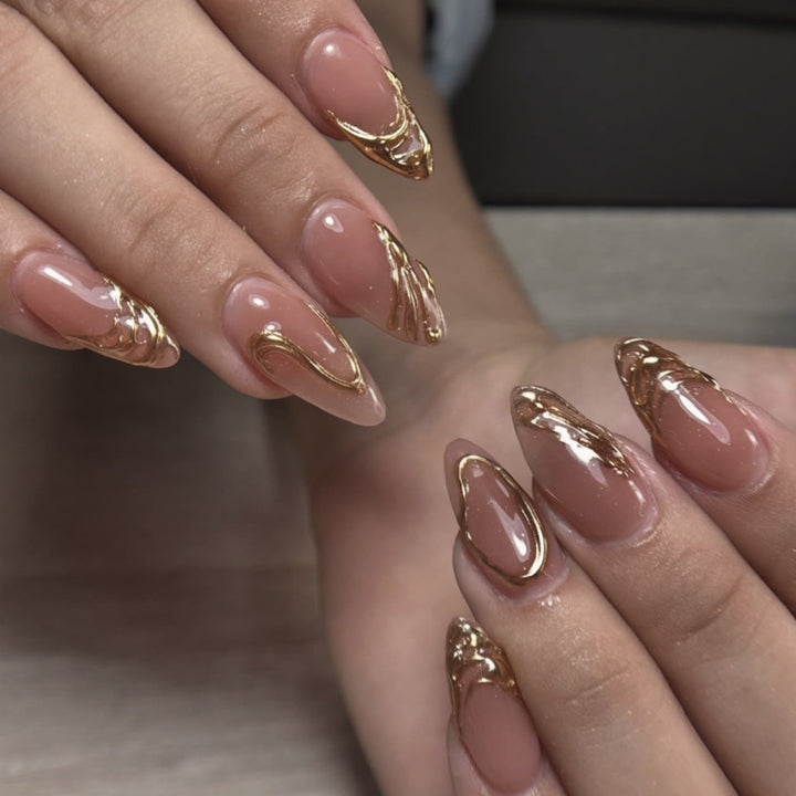 Artistic acrylic nails with gold embellishments Bowlift