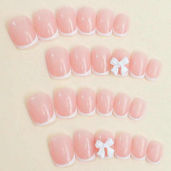 Nail set with elegant French tips and romantic floral decorations Bowlift