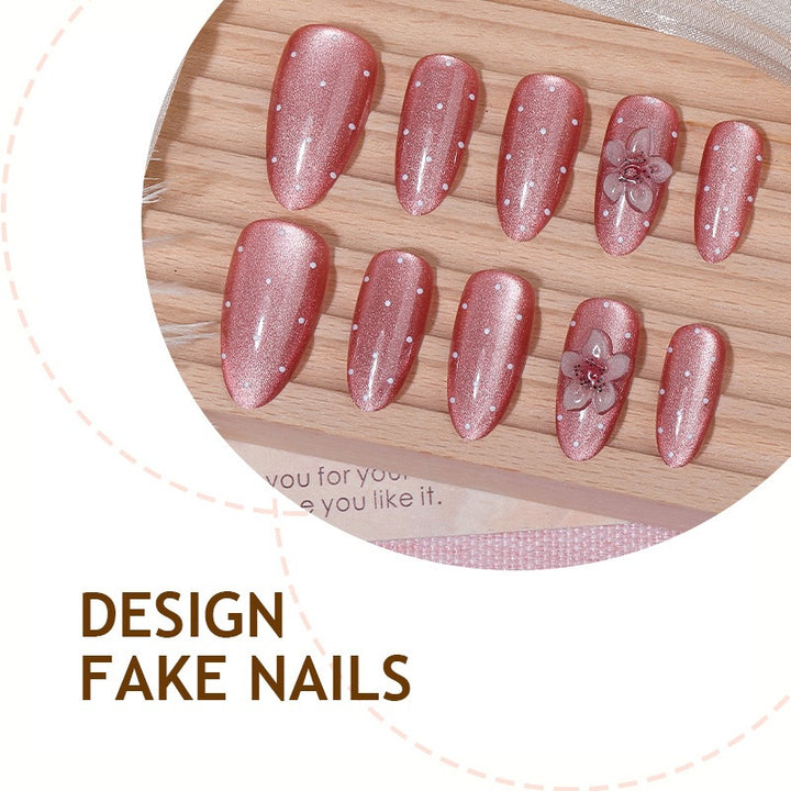 Artificial nail set with glamorous glitter design and floral accent Bowlift