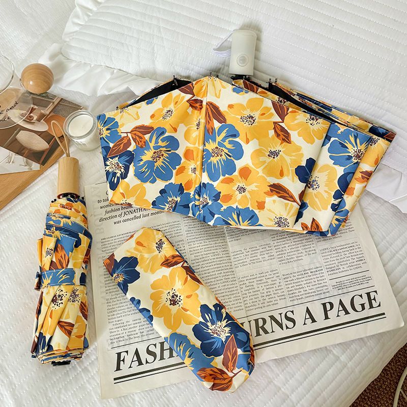 Women Folding Umbrella with Detailed Floral Design Bowlift