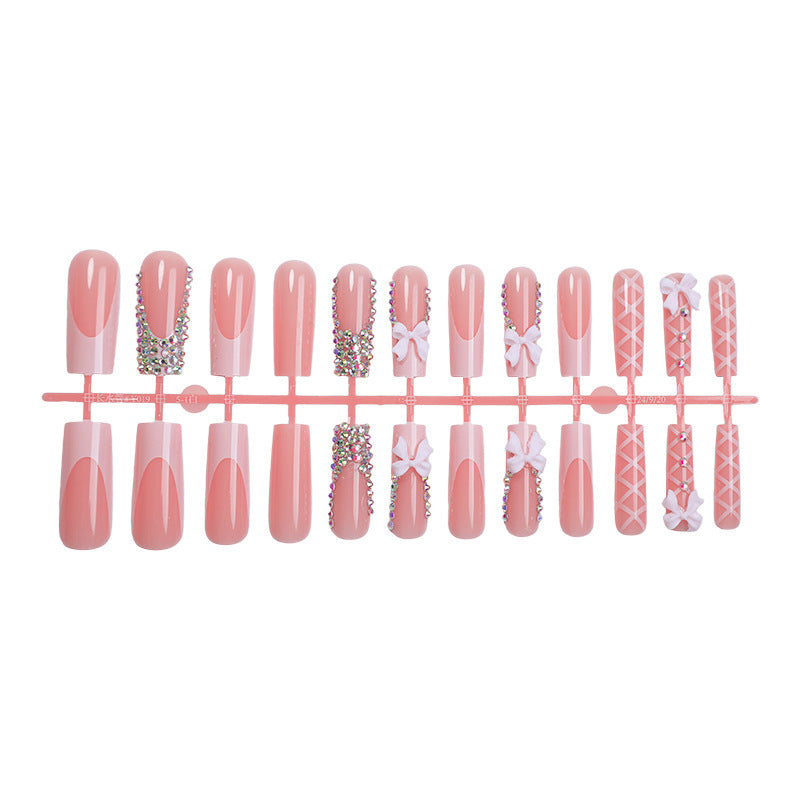 Acrylic nail set with luxurious rhinestone embellishments and bow accents Bowlift