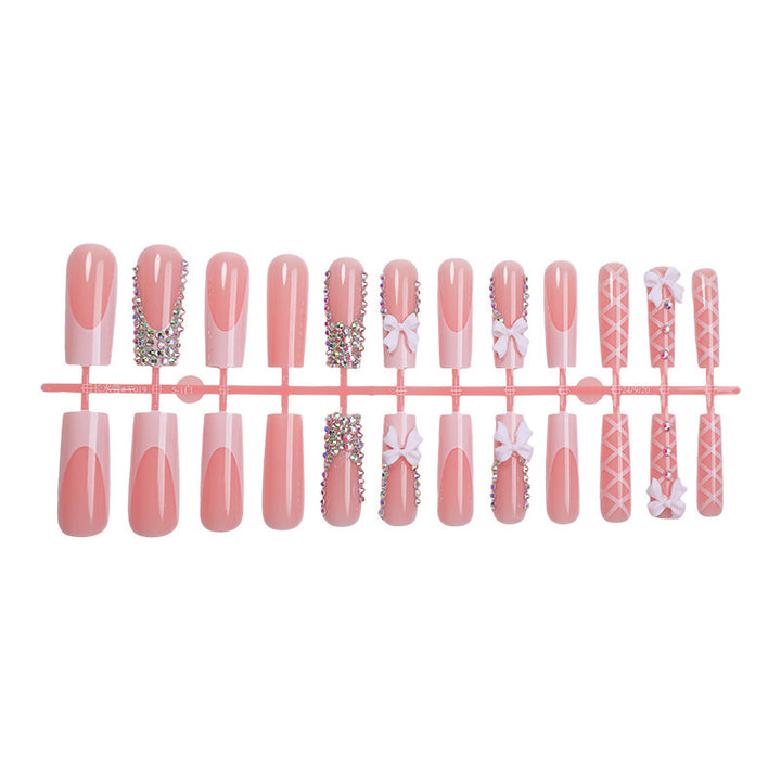 Acrylic nail set with luxurious rhinestone embellishments and bow accents Bowlift