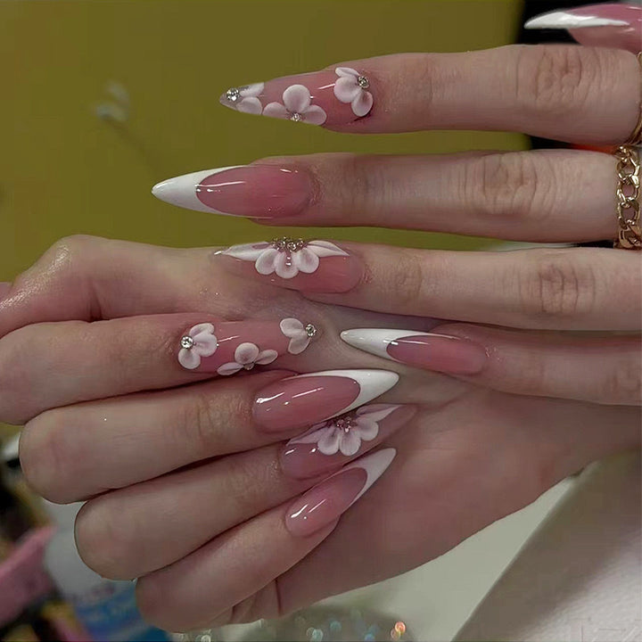 Elegant artificial nail set with floral design and glitter accents Bowlift