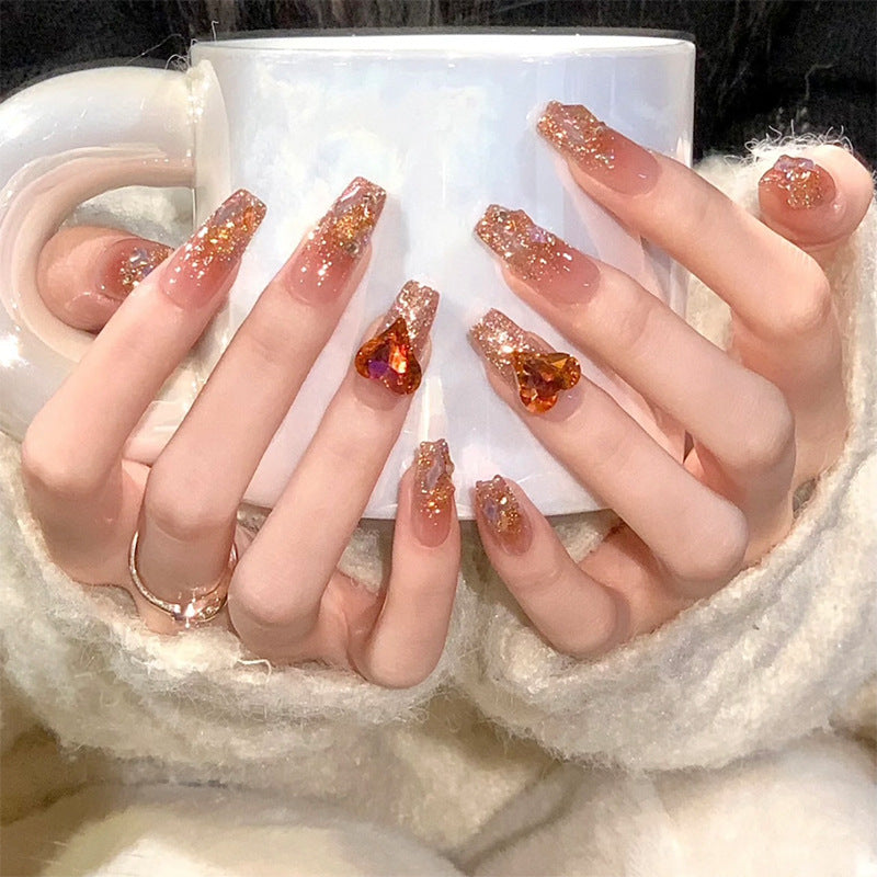 Artificial nail set with glitter and heart accents Bowlift