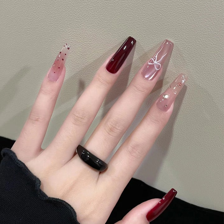 Artistic Long Press-On Nails Set with Glossy and Decorative Accents Bowlift