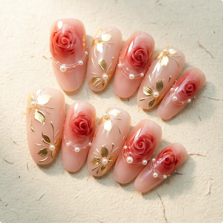 Artistic Nail Tips with Elegant Gold Jewelry Bowlift