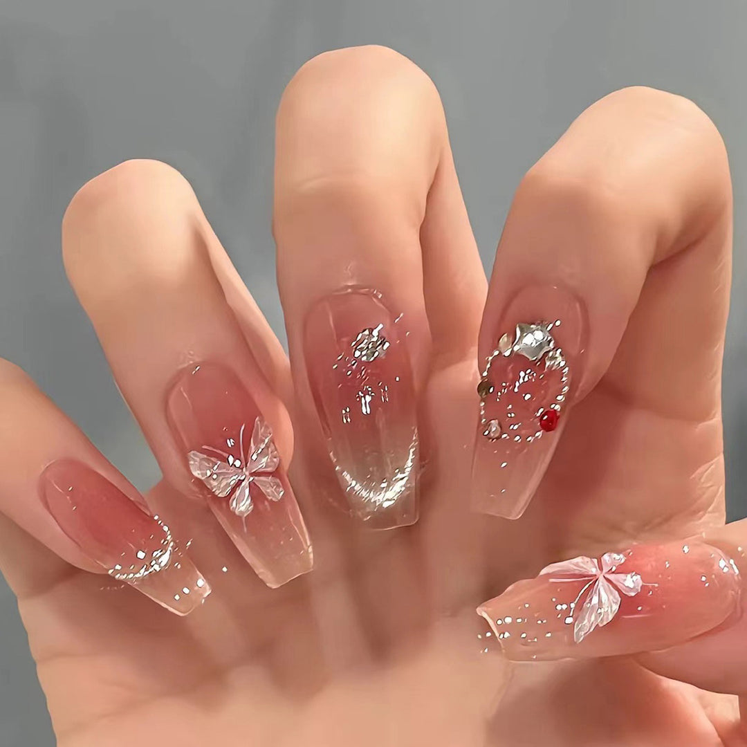 Artificial nail extensions with floral design and sparkling accents Bowlift