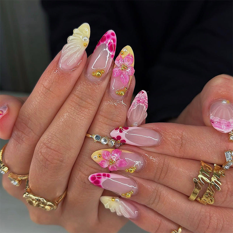 Artificial nails with floral accents and glitter decorations Bowlift