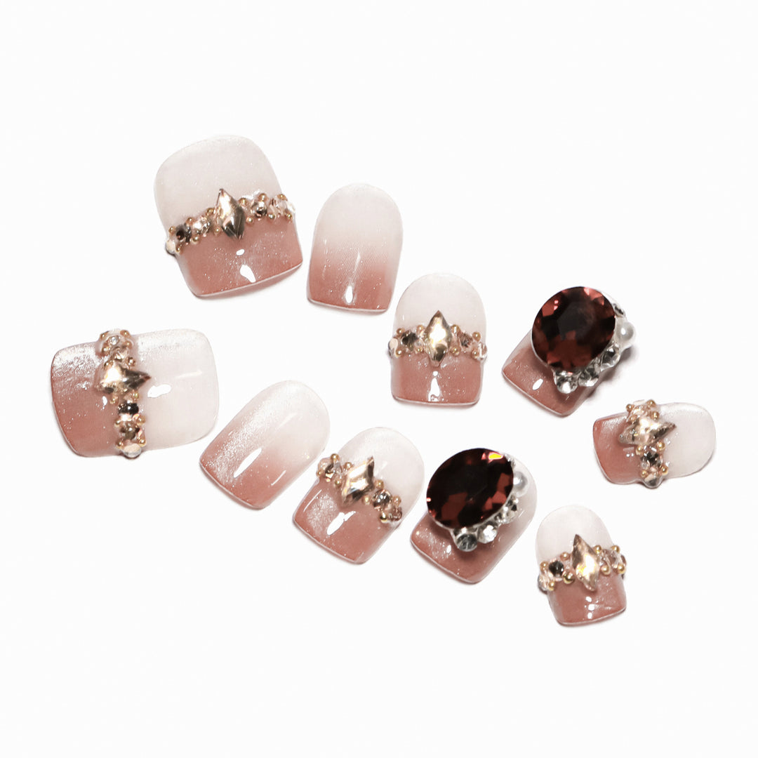 Artificial nail art with glitter and jewelry embellishments Bowlift