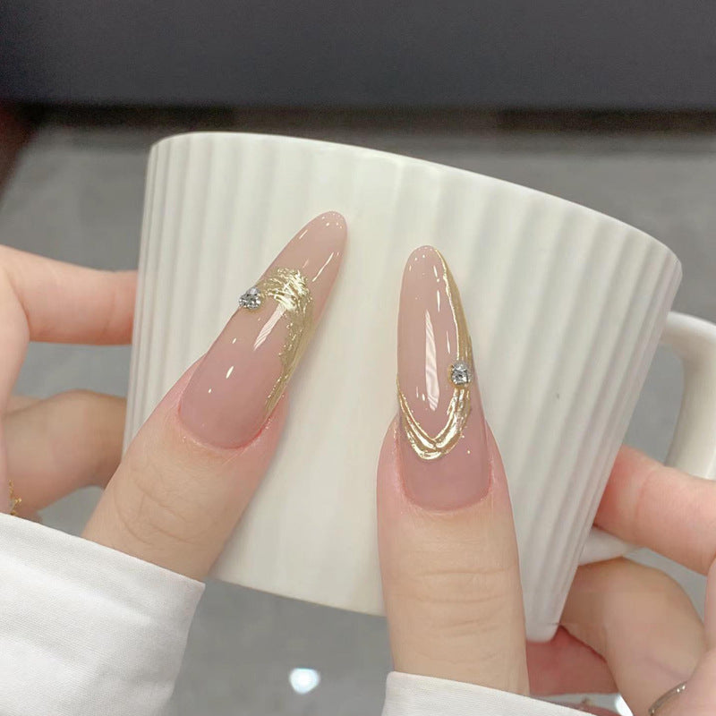Artificial nail set with elegant gold design and sparkling applications Bowlift