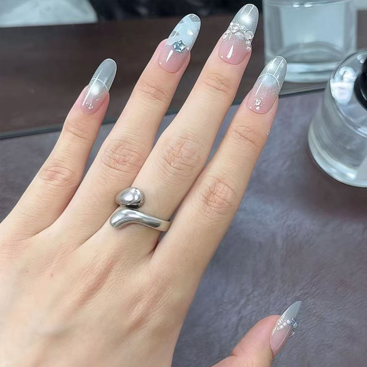 Artificial nail set with glamorous 3D details and radiant accents Bowlift