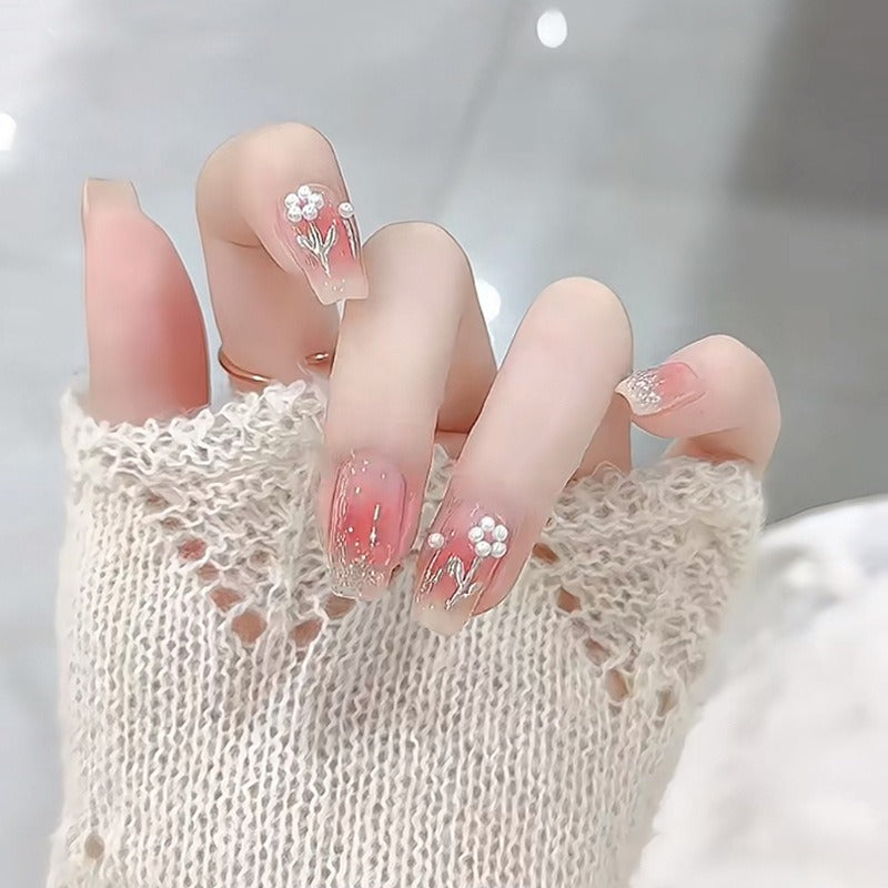 Artificial nail set with floral designs and glitter accents Bowlift
