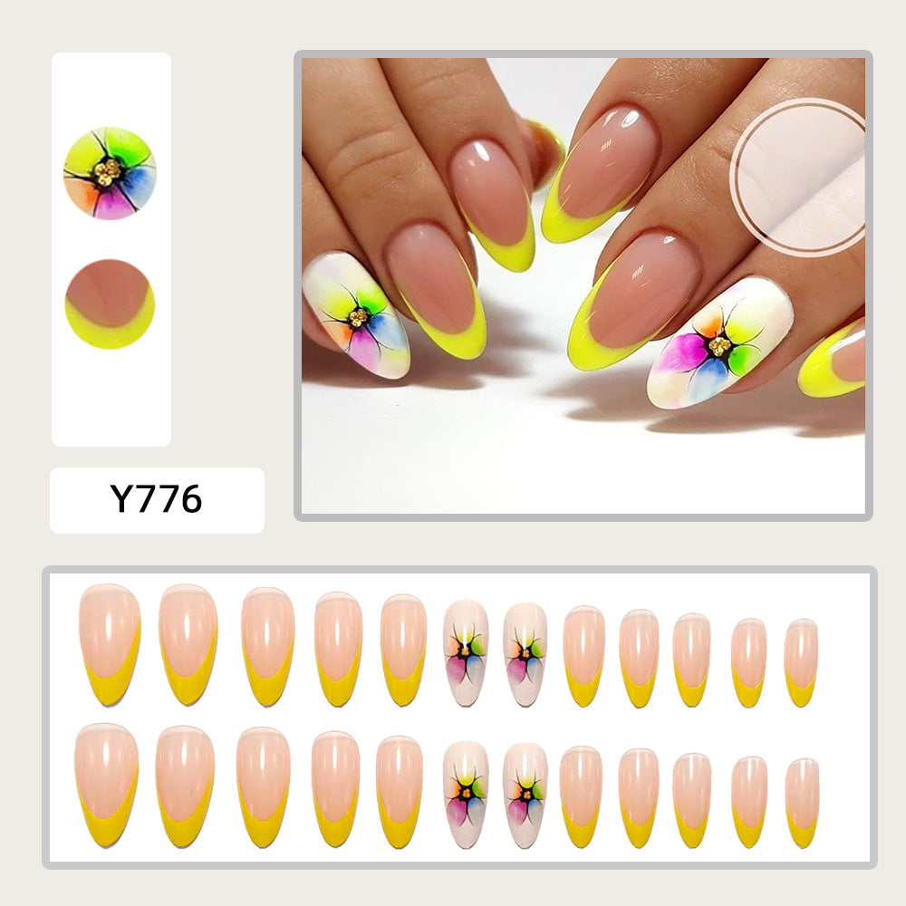 Stylish artificial nails with floral accents and colorful French tip design Bowlift