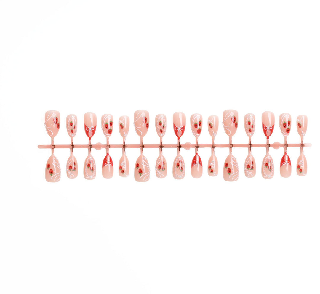 Artificial nail set with romantic strawberry and bow motifs Bowlift