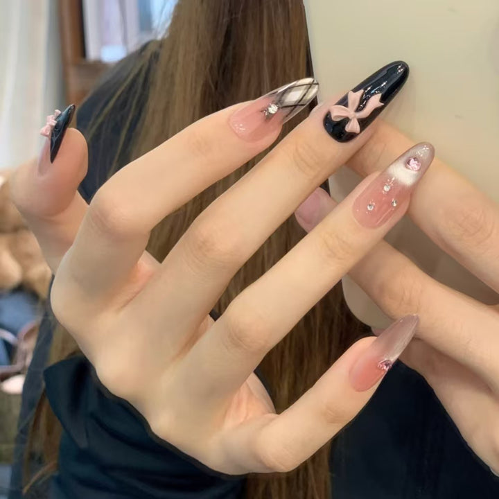 Artificial nails with playful bow and glitter accents Bowlift