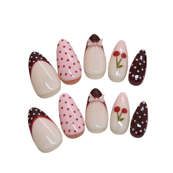 Artfully designed nail tips with cherry and dot motifs Bowlift
