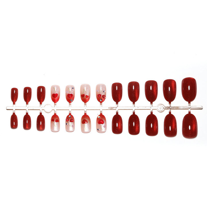Artificial nail set with glamorous accents and creative heart motifs Bowlift