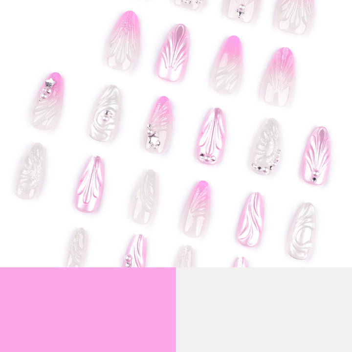 Artificial nail art with elegant swirl design and pearl embellishments Bowlift