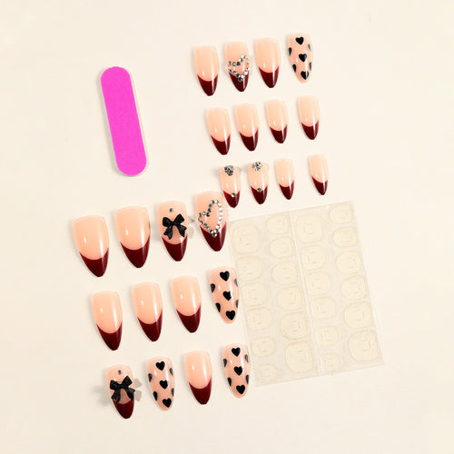 Artistic Stiletto Nail Art Extensions with Heart and Bow Accents Bowlift