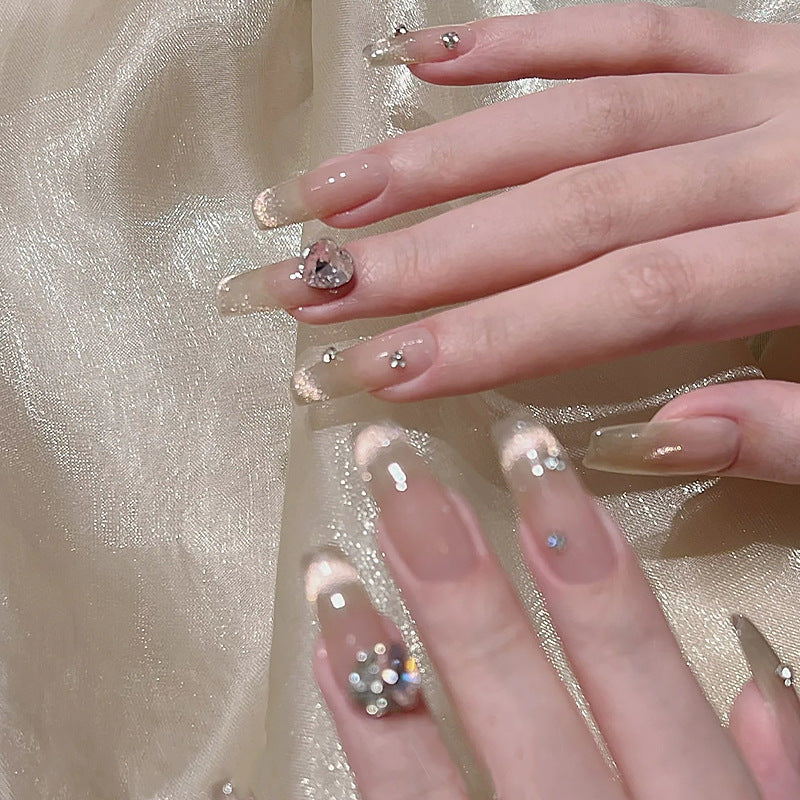 Acrylic nail set with glamorous glitter accents and elegant jewelry embellishments Bowlift