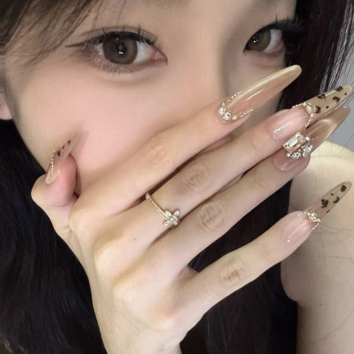 Artistic Stiletto Press-On Nail Art with Glimmering Accents Bowlift
