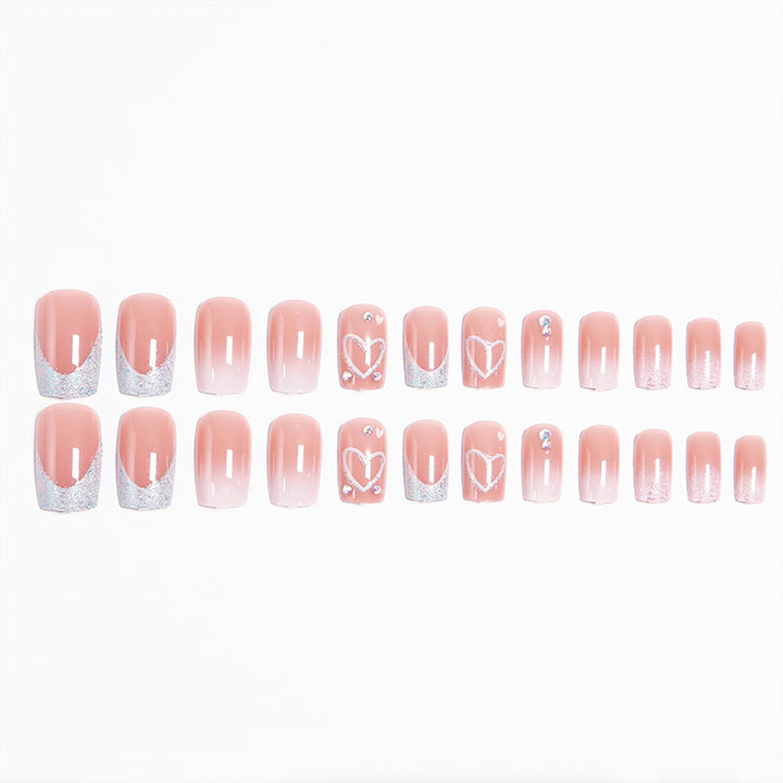 Artificial nails with sparkling heart designs and glitter details Bowlift