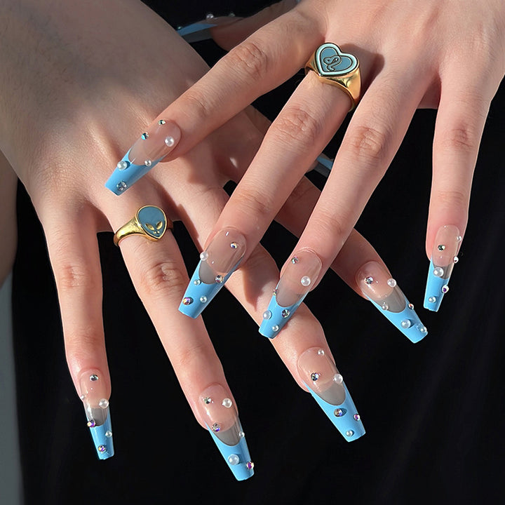 Artificial nail extensions with glitter and pearl accents Bowlift