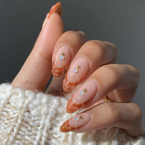 Acrylic nail set with curved tip style and glitter accents Bowlift