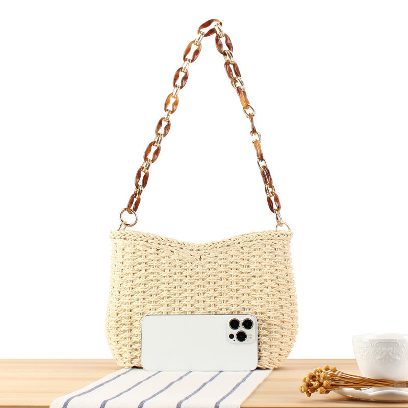 Stylish handbag made of woven natural material with exclusive chain accents Bowlift
