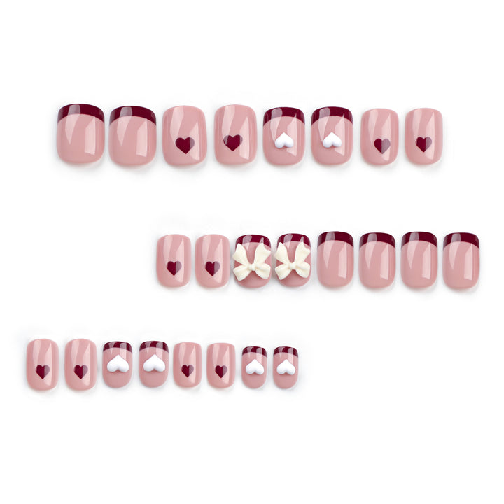 Artful nail art with heart and bow motifs Bowlift