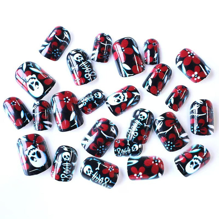 Creative nail art with skull motif and floral elements Bowlift