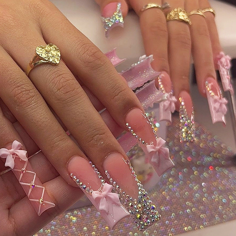 Acrylic nail set with luxurious rhinestone embellishments and bow accents Bowlift