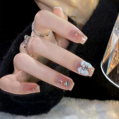 Artistic nail tips with floral and glittering accents Bowlift