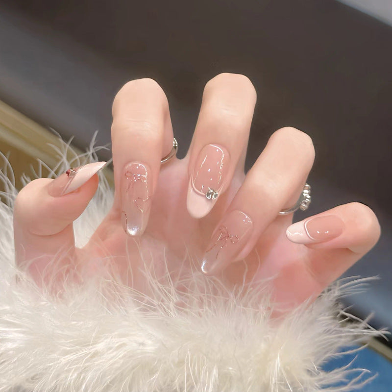 Elegant Press-On Nail Design with Decorative Accents Bowlift