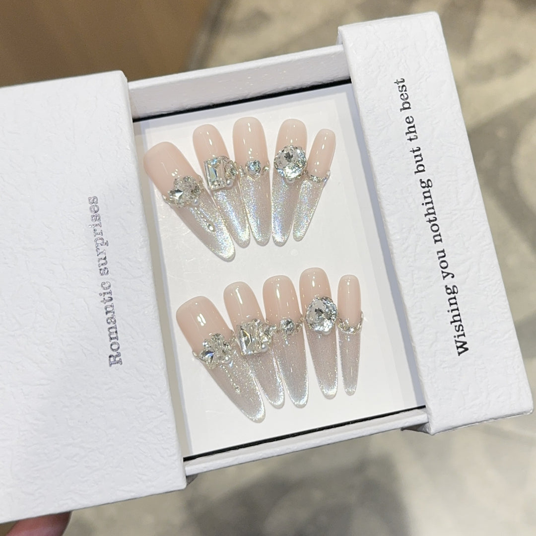 Glamorous artificial nails with sparkling rhinestone embellishments Bowlift