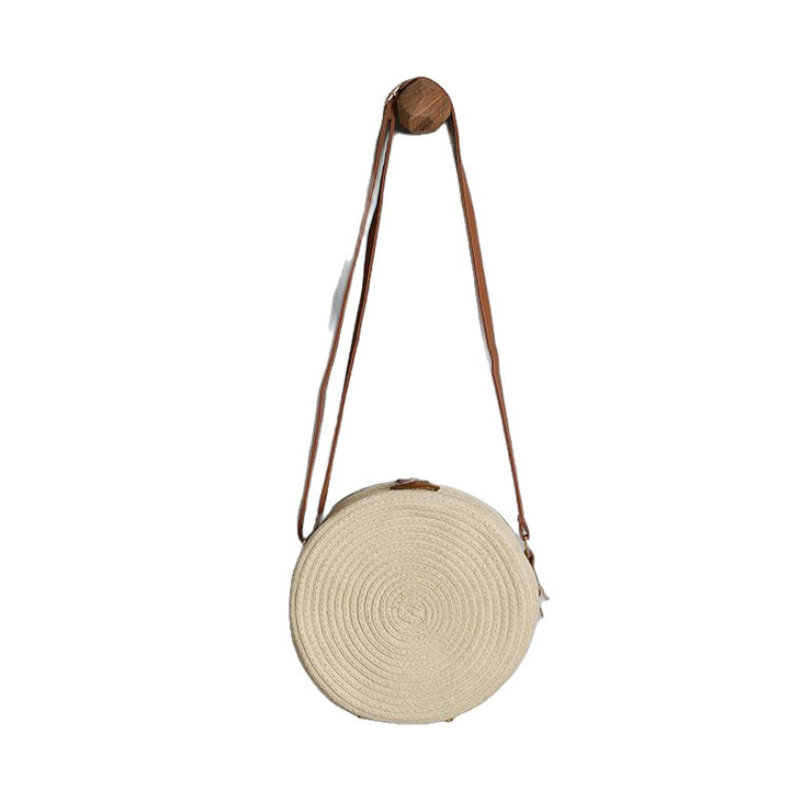Round shoulder bag made of natural material with stylish accents Bowlift
